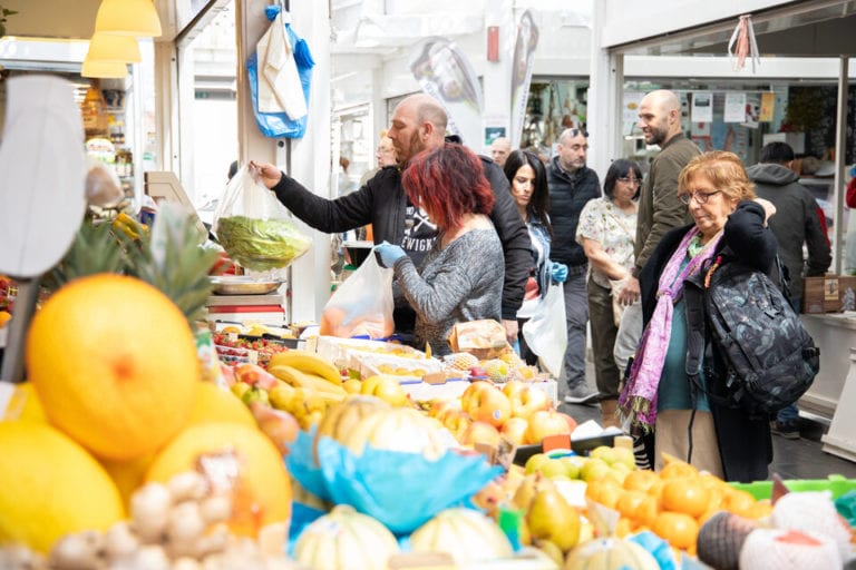 People shopping at a market in Testaccio neighborhood in Rome
